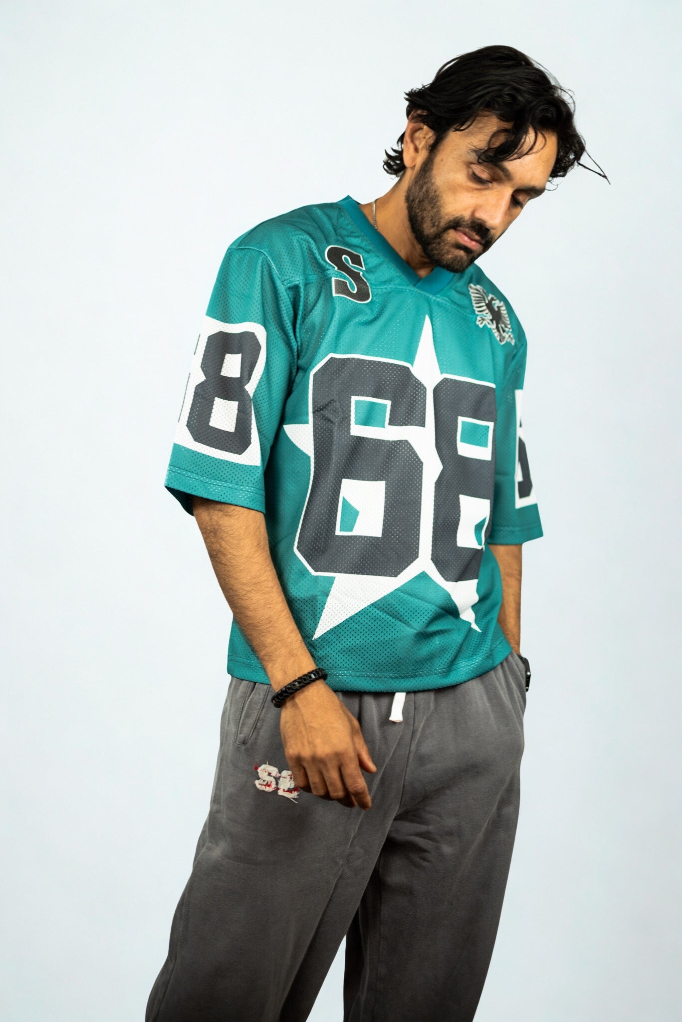 Oversized teal mesh jersey by SIDE EFFECT with bold sports lettering, urban street style with revolutionary edge