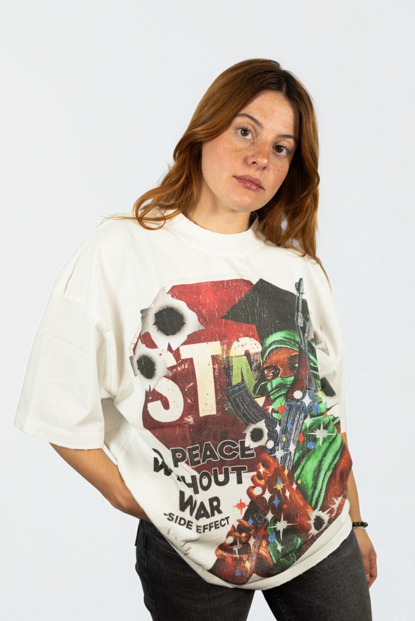 Urban streetwear oversized white t-shirt by SIDE EFFECT with cracked red graphic print, rebellious fashion movement style
