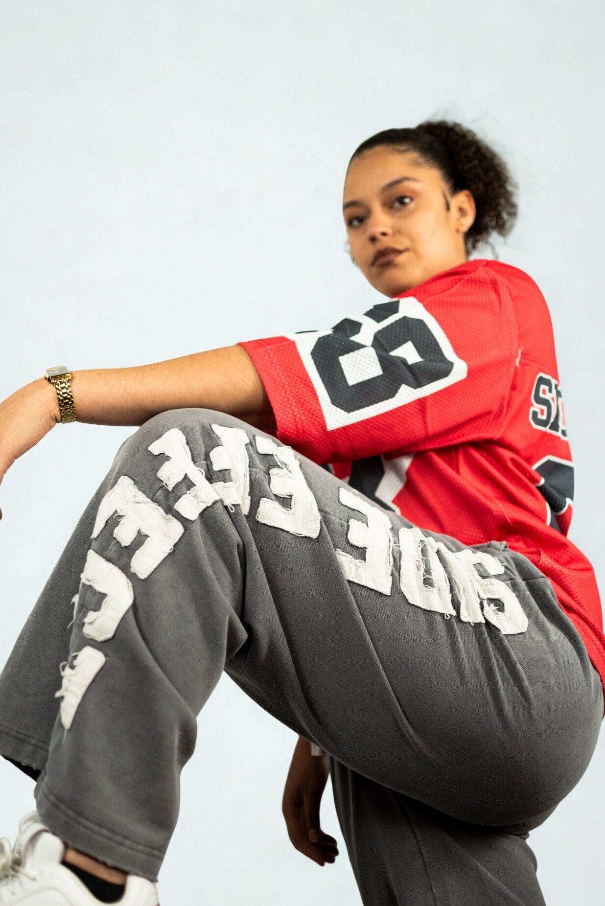 Wide-leg grey sweatpants with distressed SIDE EFFECT lettering down the leg, relaxed streetwear for urban movement fashion