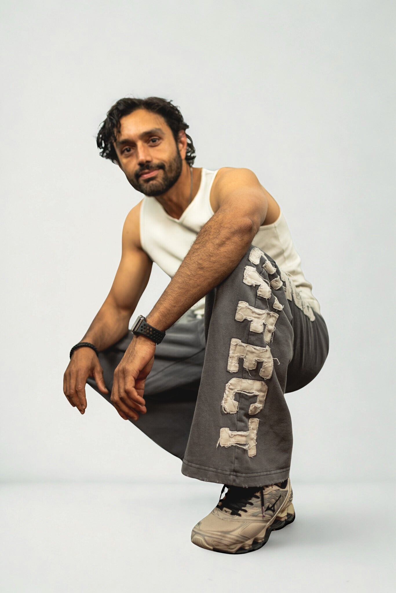 "SIDE EFFECT grey wide-leg sweatpants with oversized distressed appliqué lettering down the leg, relaxed fit streetwear for urban cool fashion"